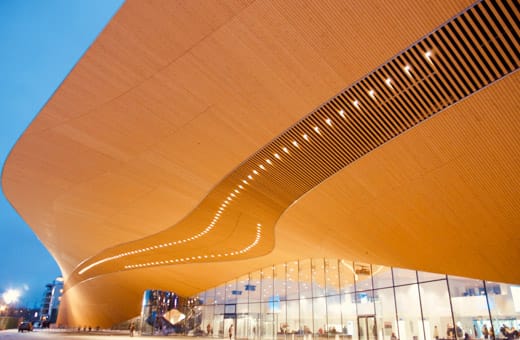 Curved wooden architectural building, library called Oodi in Helsinki.
