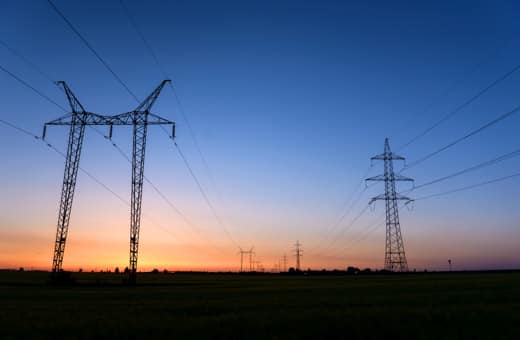 Electricity transmission lines against a blue sky